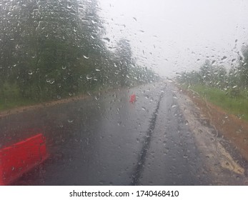 
raindrops falling down the car glass