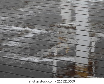 Raindrops Falling On Wet Wood Plastic Composite Floor Of Walkway Texture