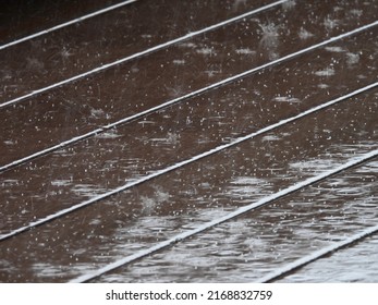 Raindrops Falling On Wet Wood Plastic Composite Floor Of Walkway Texture