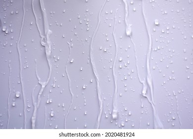 Raindrops fell on the wall and saw the raindrops flowing in a long way.The water flowed through the walls as a stream of water splashed and saw beautiful patterns. - Shutterstock ID 2020481924