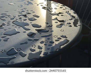 Raindrops on a cafe table.