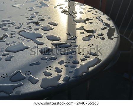 Raindrops on a cafe table.