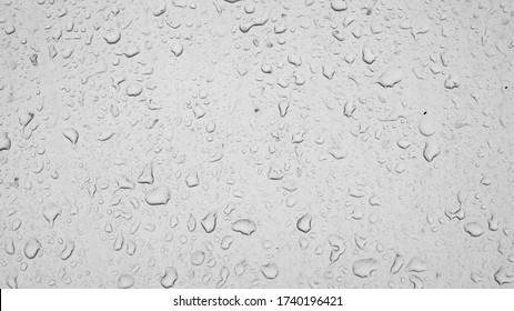 raindrops on car glass, texture of water drops on a dusty window. Textured effect background wallpaper backdrop, black and white raindrops weather