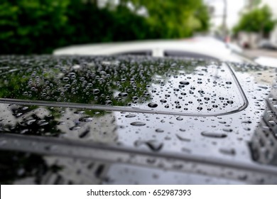 Raindrops on car sunroof. selective focus