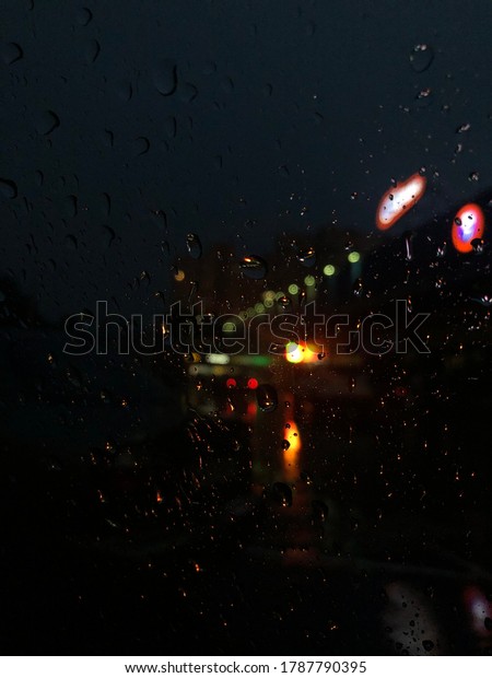 raindrops on a\
car window overlooking the night\
city