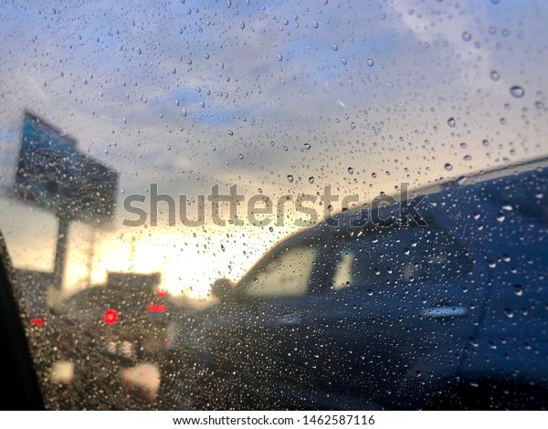 Raindrops on car window in
sunset light