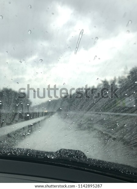 
raindrops on
the glass of a car, a journey, a
road