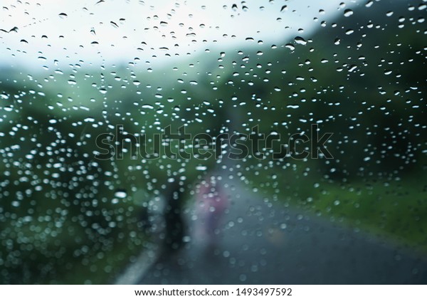 Raindrops on glass, raindrops on a car transparent\
glass .