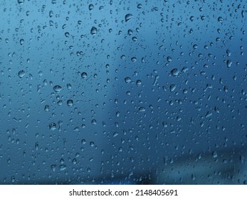 Raindrops On The Glass, Water Drips, Dark Autumn Clouds. The Concept Of The Bad Weather Forecast.