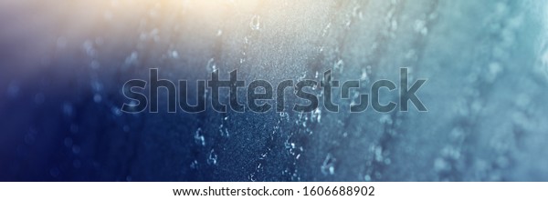 Raindrops on gray-black walls, glass on\
cars, rain drops on clear windows or raindrops on glass of\
raindrops or window vapors, clear blue-white water\
droplets