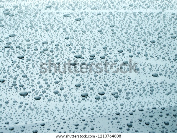 raindrops on the hood of a black car                    \
         