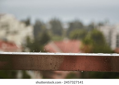 Raindrops on an iron handrail, wet handrail, caution slippery railings, wet railings, water on metal, close-up - Powered by Shutterstock