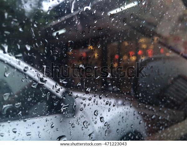 raindrops\
on a side window of car viewed from the\
inside.
