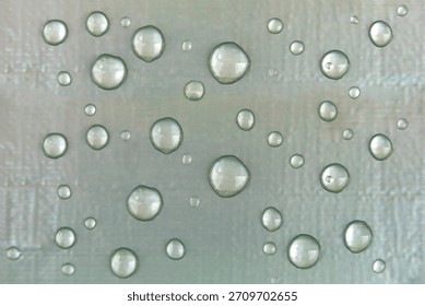 Raindrops on a silver matte background