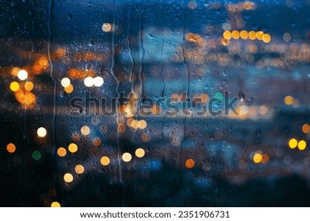 raindrops on the window and Bilbao city background