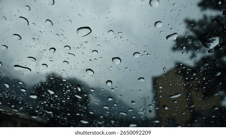 Raindrops on a window with blurred background