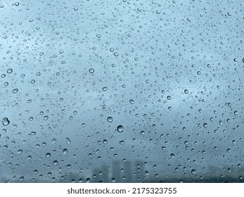 Raindrops On Window. Dark Cloudy Background. Raindrop Pattern On Window