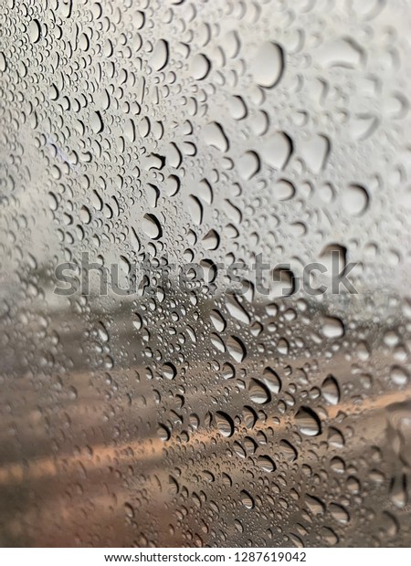 Raindrops on window during\
rain storm
