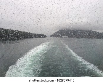 Raindrops On Window With Ferry Wake And Islands In Background