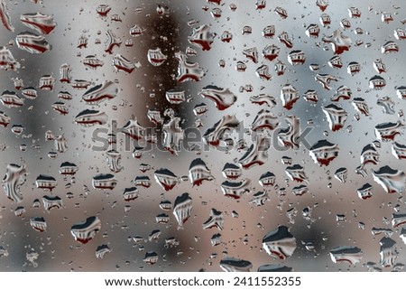 Similar – Drops on the window pane with reflection of the building opposite