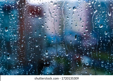 Raindrops On Window Glass. Selective Focus. Rainy City Background