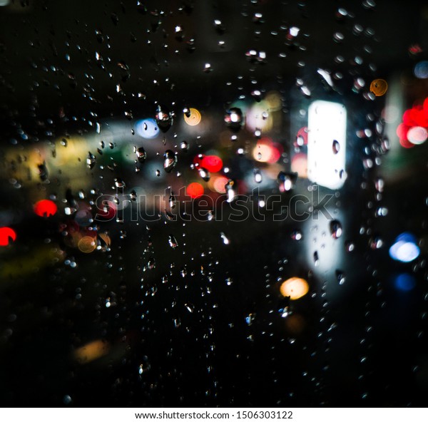 Raindrops on a window at night. The backdrop to
adjust a bokeh