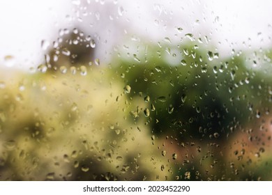 Raindrops On The Window With Out Of Focus Backyard Bokeh During A Cold Winter Storm Shot In Australia