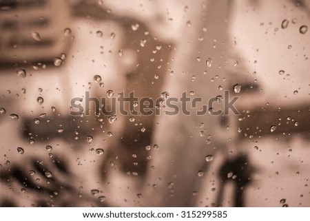 raindrops on a window on the street blurred background