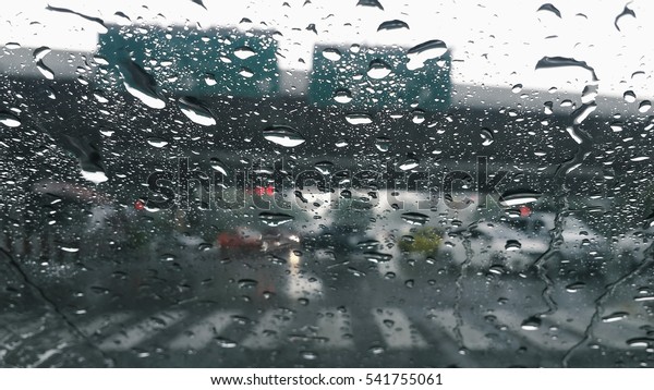 Raindrops on the window\
while driving car.