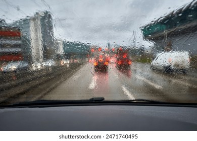 Raindrops on the windshield. Rush hour traffic in the city. Cockpit view. - Powered by Shutterstock