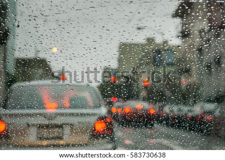 Raindrops on the windshield while driving through San Francisco on a rainy day, California