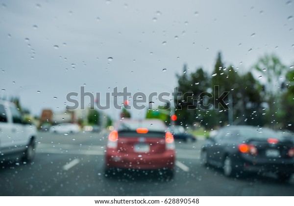 Raindrops on the windshield while driving on a\
rainy day, California