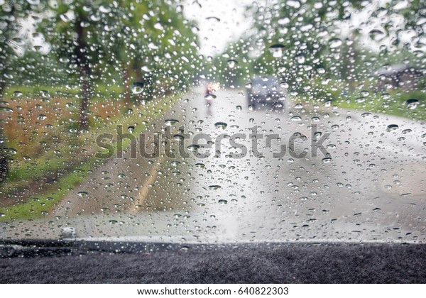 Raindrops on\
the windshield while driving on\
Thailand