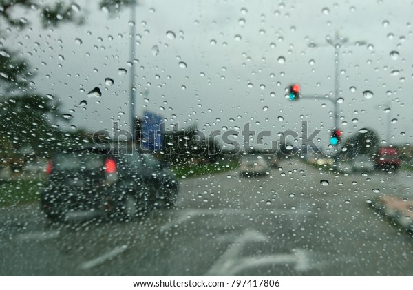 Raindrops on the windshield while driving on a\
rainy day\
\
