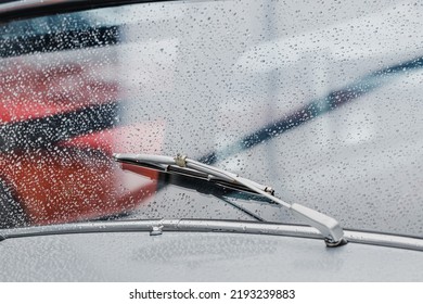 Raindrops On The Windshield And Working Wipers Of A Retro Car. Cinematic And Atmospheric Mood Of The Picture