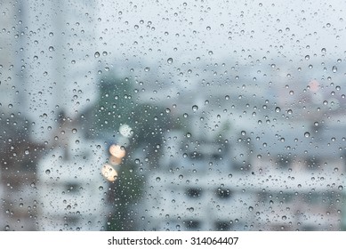 Raindrops over the window with blurred background in vintage sad tone
