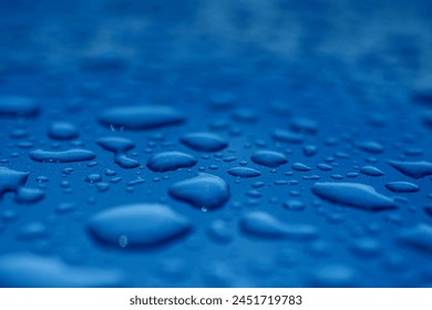 Raindrops splashed on car windshields and house windows.