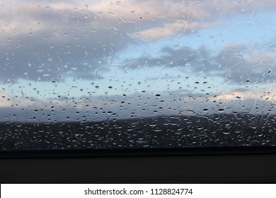 raindrops window cloudy sky