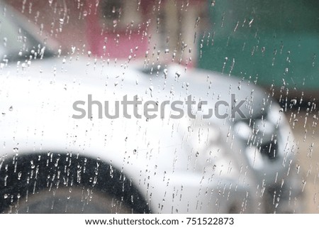 Rainfall  water drops on the car glass wet and blur on street