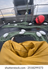 Raingear and corks on the back deck of a commercial fishing vessel.