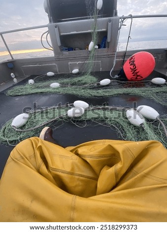 Raingear and corks on the back deck of a commercial fishing vessel.