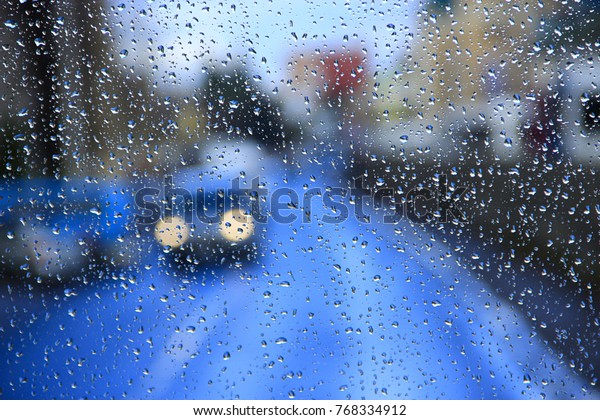 it\'s raining behind\
the window in the city