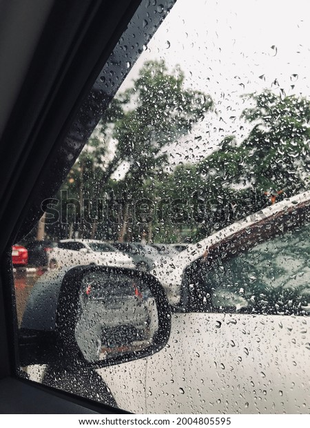 raining but in car and\
mirror