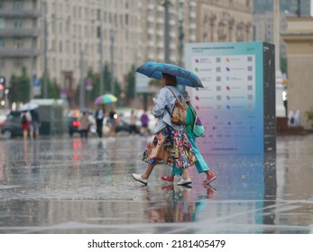 Raining Day In City Center At Summer. Wet People. Umbrella As Protection. Young Mother With Daughter. Texture Of Strong, Fresh And Powerful Water Drops And Sprays. Tropical Storm