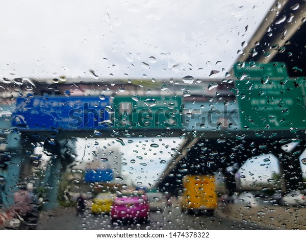 Raining day
in the traffic, rain drop on the
window.