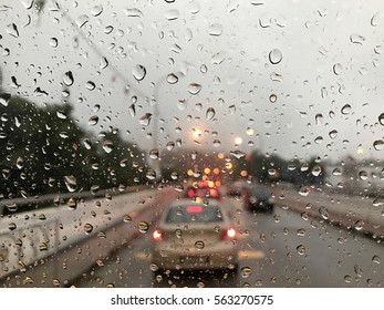 Raining Day Trough The Car Windows In Malaysia Road During Monsoon