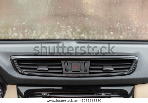 raining on car windshield and air flow in\
car. Car air conditioning. Detail interior of\
car