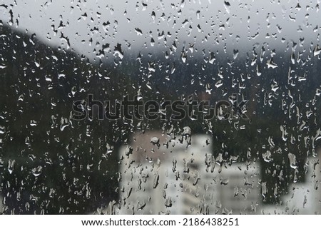 Raining outside window ( view of Hong Kong residential area )