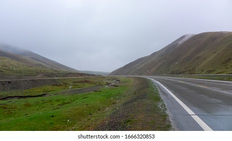 Raining Prairie Road. Gonghe County, Hainan Tibetan Autonomous Prefecture, Qinghai, CHINA