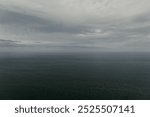 Raining sky over the Atlantic Ocean, Tenerife. Minimalism. Misty morning in the sea. Calm view. Tranquil empty landscape with soft blue gray sky. Natural gloomy weather.